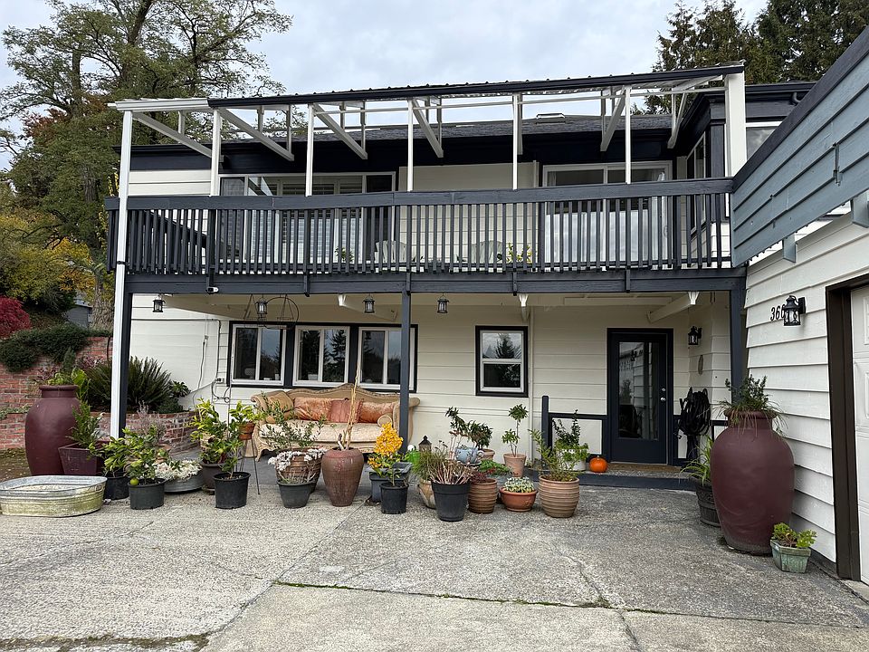 South facing entrance with plants and day bed for seating.