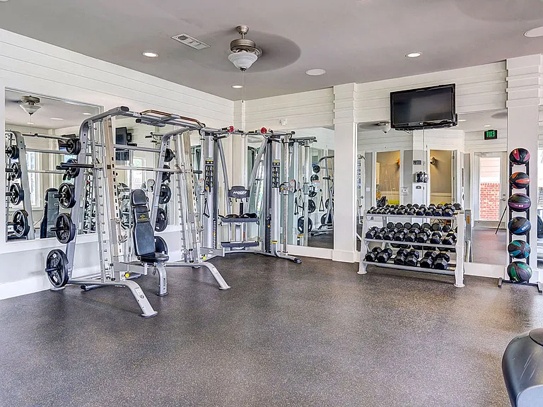 State of the art fitness center with dumbbells and weight machines