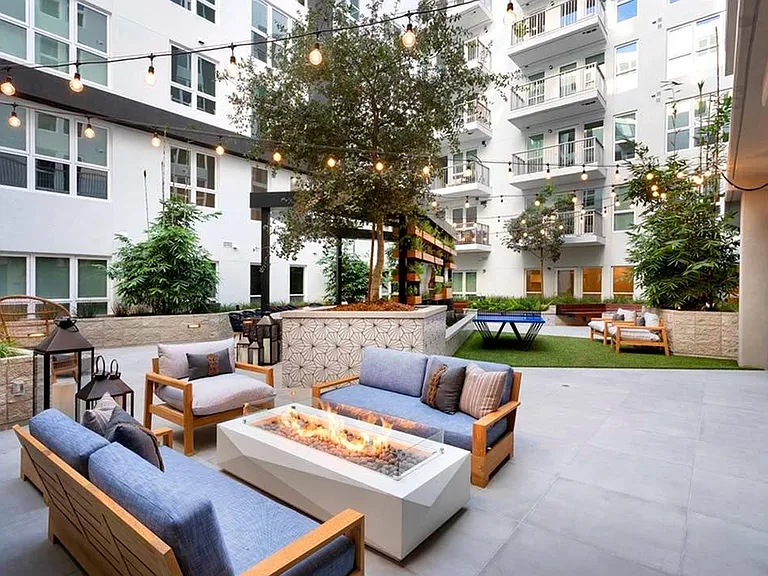 Gather around a firepit under sparkling string lighting in one of two stunning courtyards at Modera San Diego