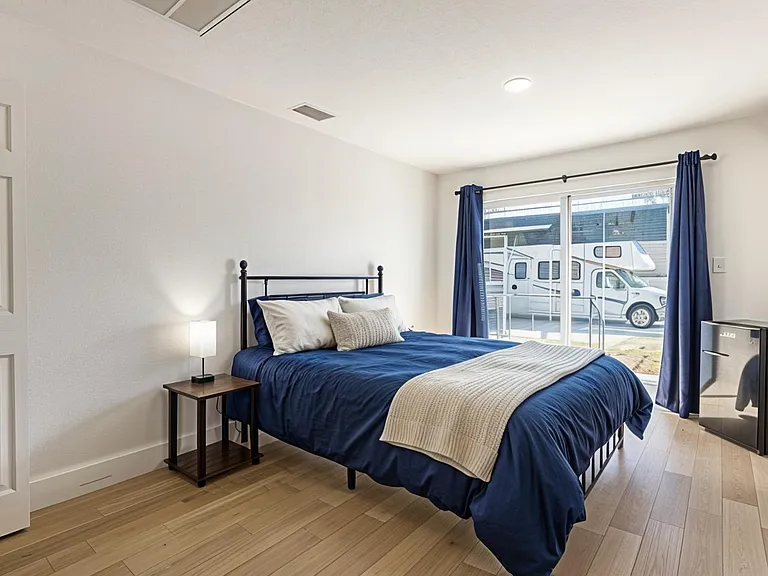 Bedroom with own bath, desk, small fridge, dresser, closet, natural light, mini split and private entry.