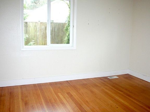 Master Bedroom on the main floor. Beautiful hardwood floors, nice windows and upgraded lighting fixture.