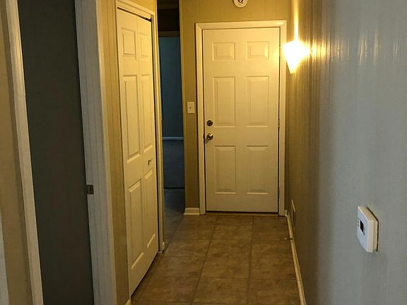 Front Hallway showing front entrance door, and doors to Front Bedroom, large coat closet, and second bedroom.