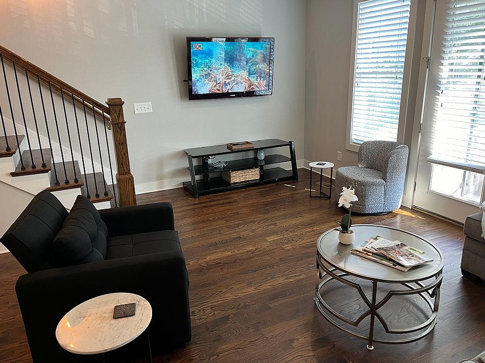 2nd floor living space next to kitchen with TV, large sectional
