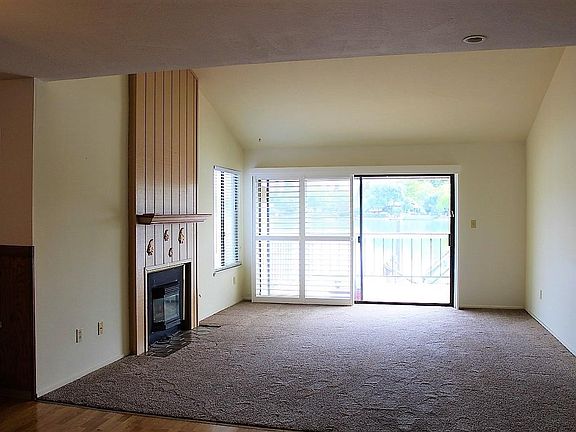 Living Room includes Vaulted Ceiling, sliding door for natural light and access to rear deck/waterfront access.