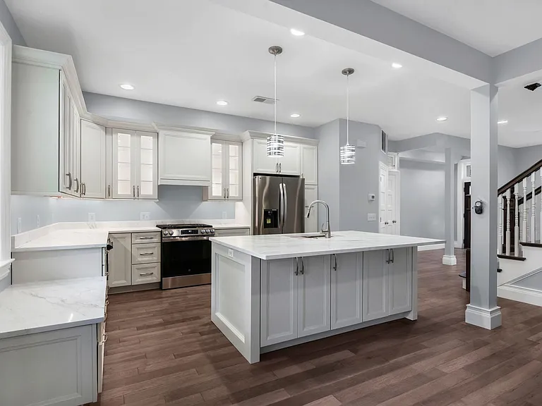open plan view showing multiple downlights and pendant island lights