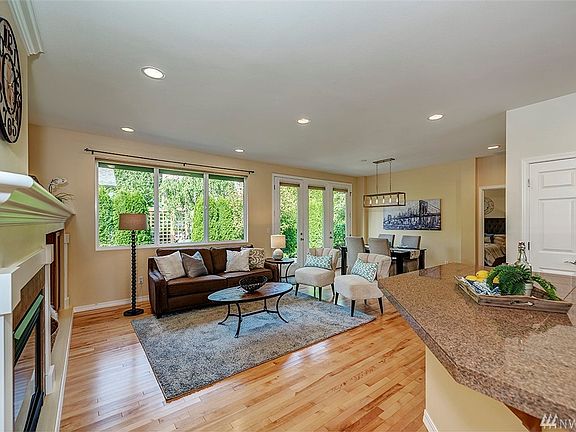 Step past the entry and enter the great room. The kitchen is behind the breakfast bar on the right.