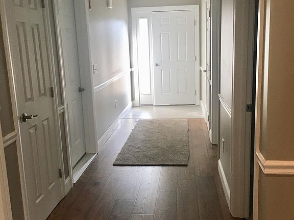 HEADING TO FRONT DOOR ENTRANCE RIGHT TO GUEST BATHROOM AND BEDROOM. ENTRANCE LEFT TO GARAGE