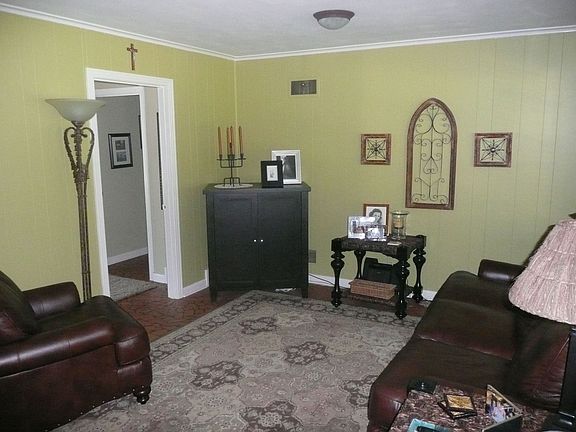 Den has fireplace and access to back yard.
