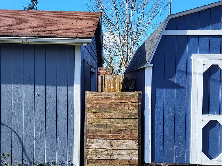 Big shed next to mostly finished garage.