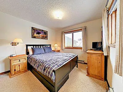Room with queen bed.