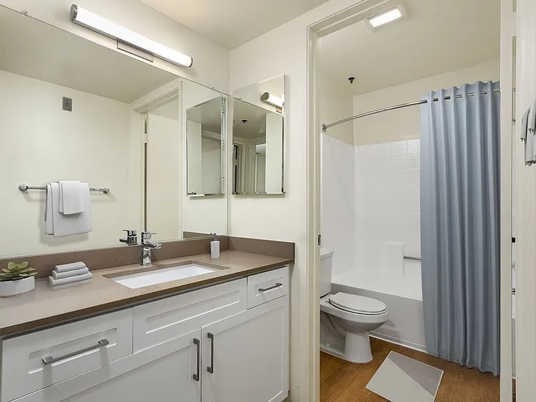 Renovated I bath with quartz countertops and hard surface flooring