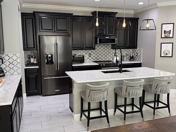 Italian marble backsplash, porcelain tile throughout