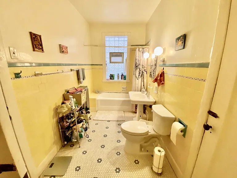 Large bathroom with beautiful vintage tiling (walls are painted white!)