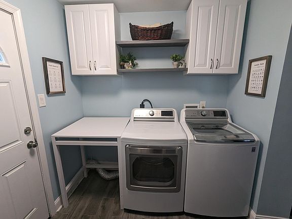1st floor laundry room with doorway to back patio