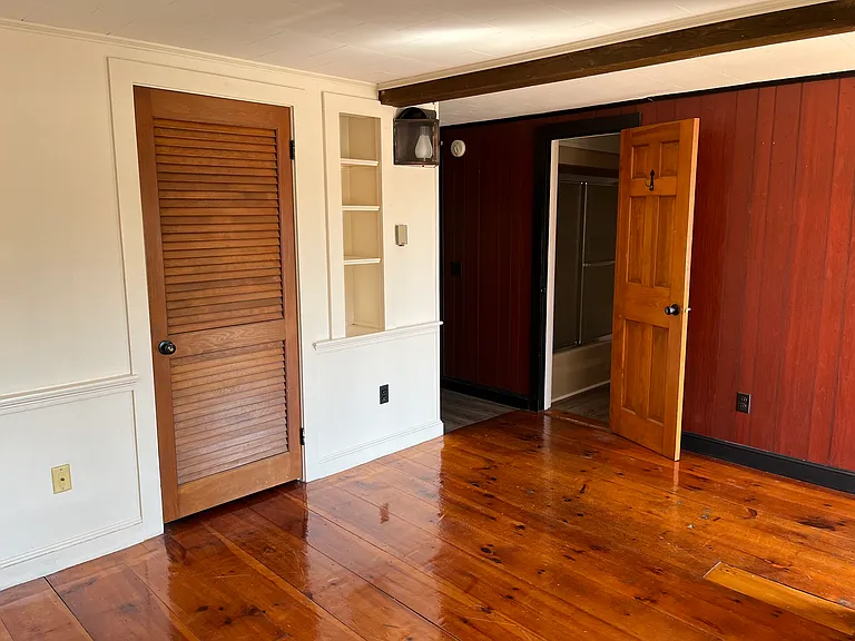 Other side of living room with closet.