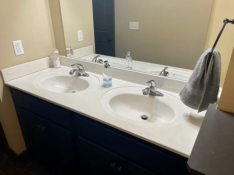 Double vanity and shower/tub combo in primary bathroom.