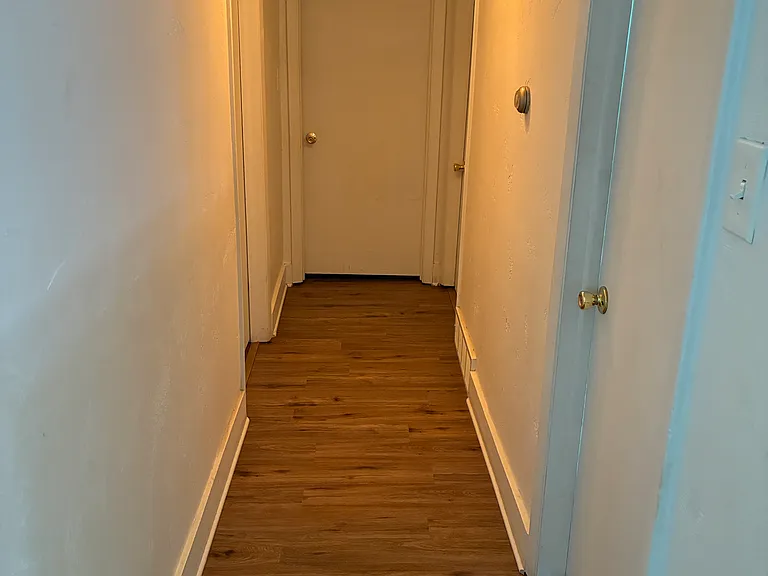 hallway from kitchen/living going to the bedrooms, laundry and bathroom