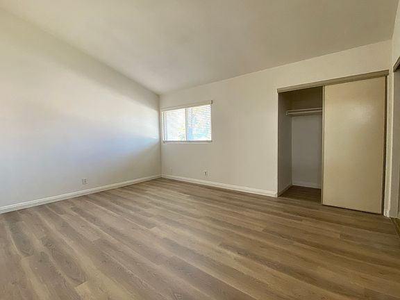 Primary bedroom with vaulted ceiling