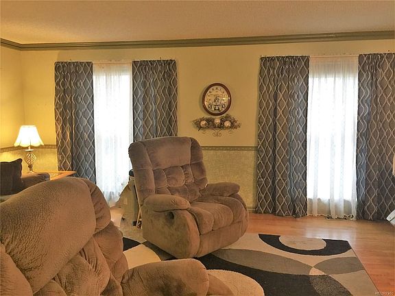 Nice living room open to the dining room and kitchen. Two large windows, curtains are included.