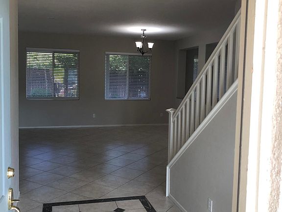 Open entry looking into living and dining rooms. Tile floors in all downstairs living areas.