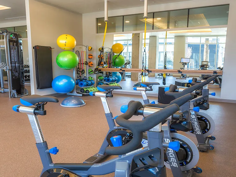 Fitness studio with cycling bikes and colorful equipment for dynamic sessions.