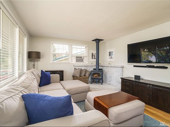 Wood stove for warmth and atmosphere...great living spaces throughout!  Attached TV screen is excluded.