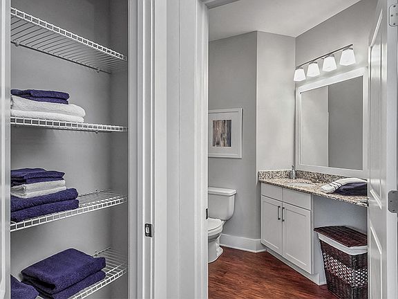 Baths with linen closets and framed mirrors