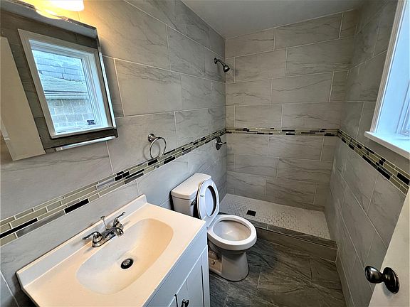 New first floor bathroom with ceramic tile floor and shower surround