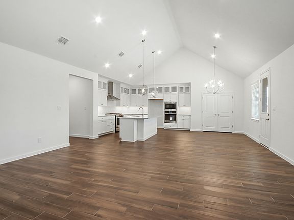 Soaring vaulted ceiling unites main living spaces