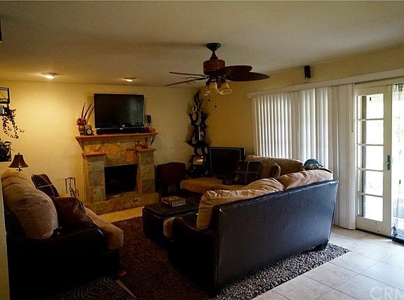 Cozy living room with fireplace - sliding French doors to re