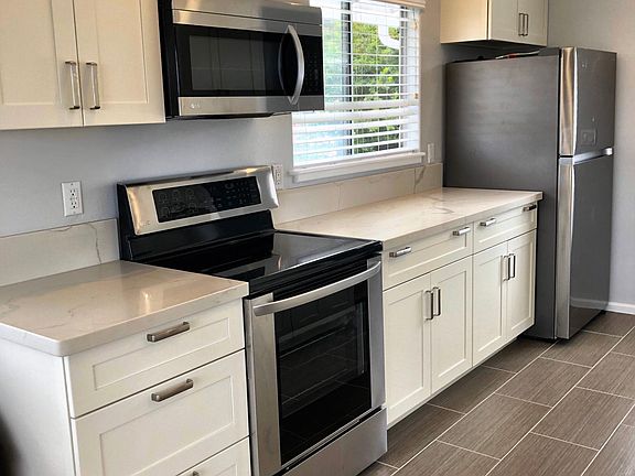 Full sized stove, full sized fridge, vented microwave