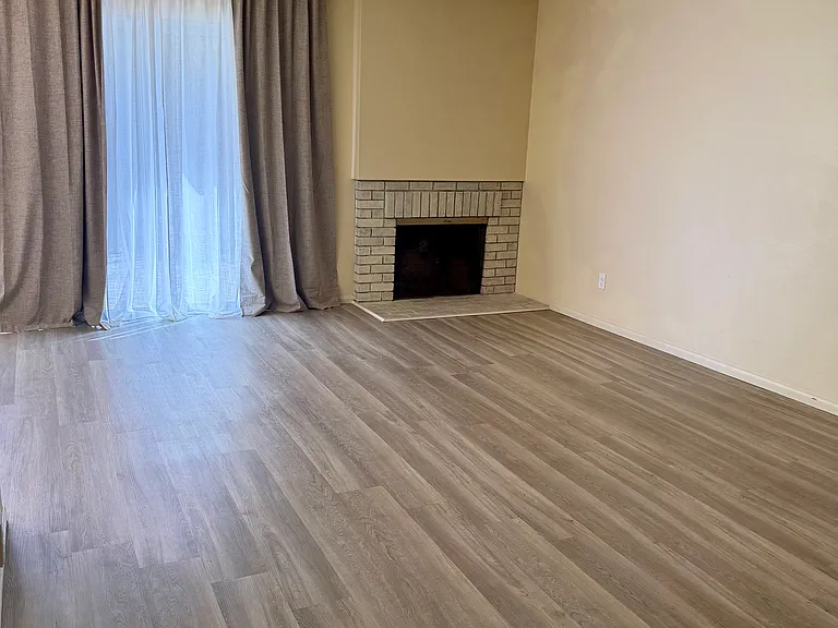 Main living room, opens into dining nook with sliding door to private back yard.