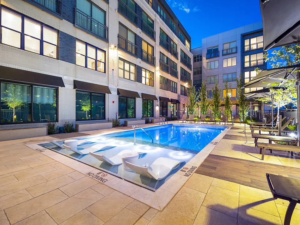 Resort-style pool with Sunbrellas and in-pool chaises