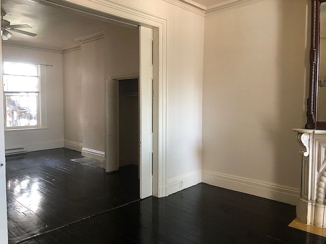 Pocket doors between parlor and large bedroom.