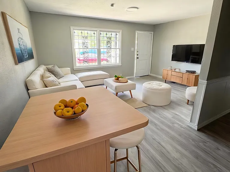 Staged living room and kitchen eat in area.