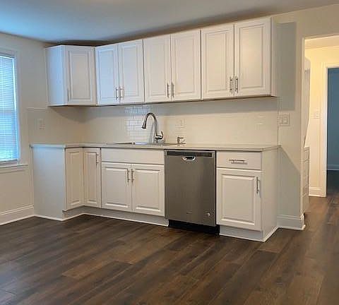 Spacious updated kitchen with stainless steel appliances, including dishwasher, stove, and refrigerator. Ample cabinet space!