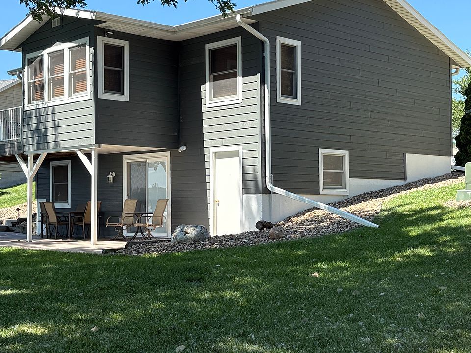 Back of house overlooking lake with deck off dining room - main level and patio off famiy room - lower level.