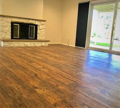 Large Living Room / Family Room with sliding doors to covered patio and private, fenced backyard.