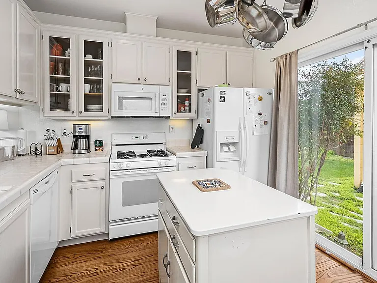 Slider in kitchen leads to Patio and Yard.