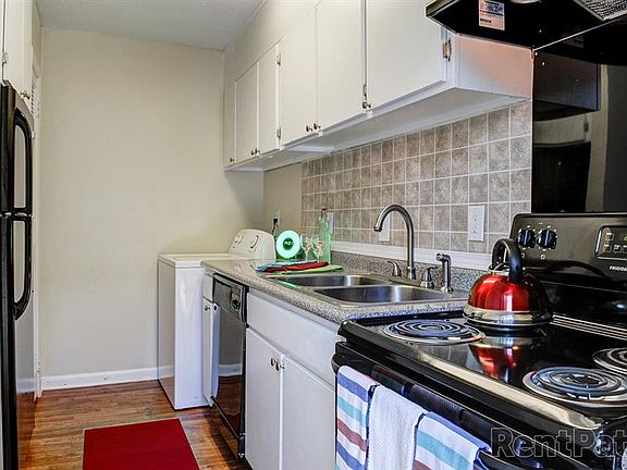 Kitchen with Black Appliances and White Cabinetry