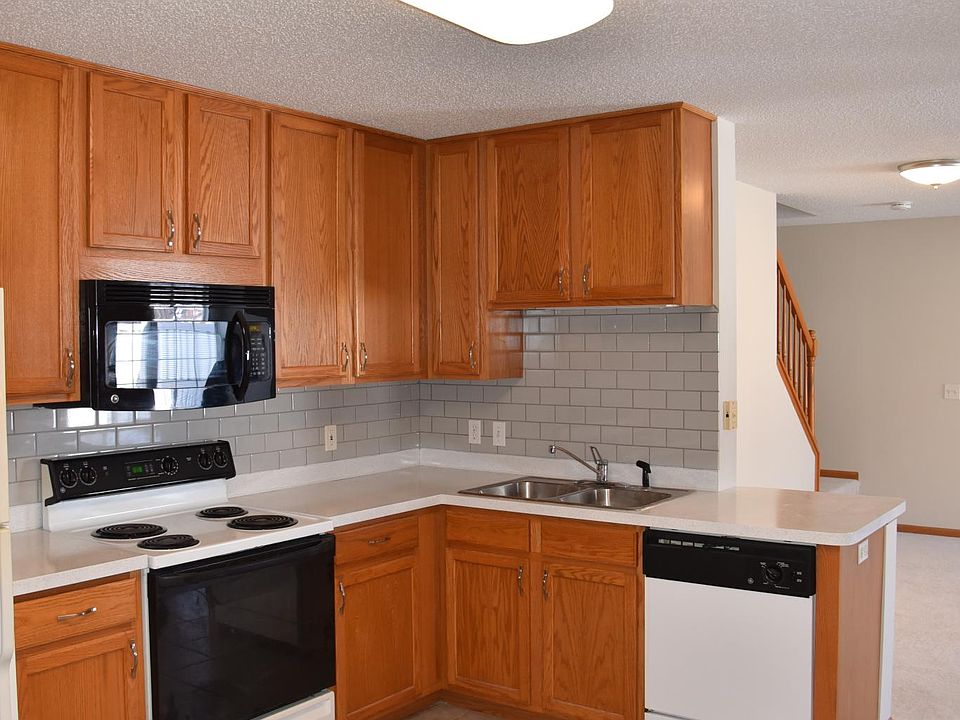 Open kitchen with updated counters and subway tile backsplach - large open area with room for kitchen table