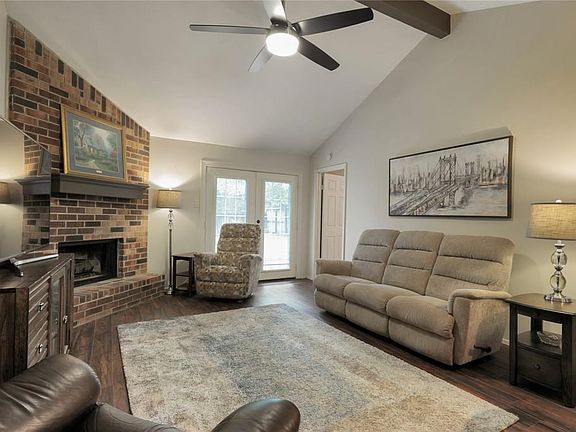 The family room has gorgeous wood look tiled flooring , a new ceiling fan and French doors going out to the extended patio and private fully fenced backyard !