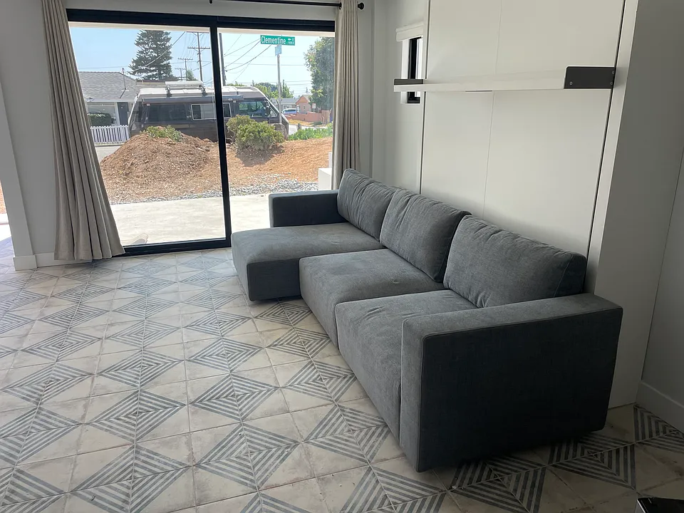 Queen-size Murphy bed closes easily into a luxurious Italian couch and chaise.