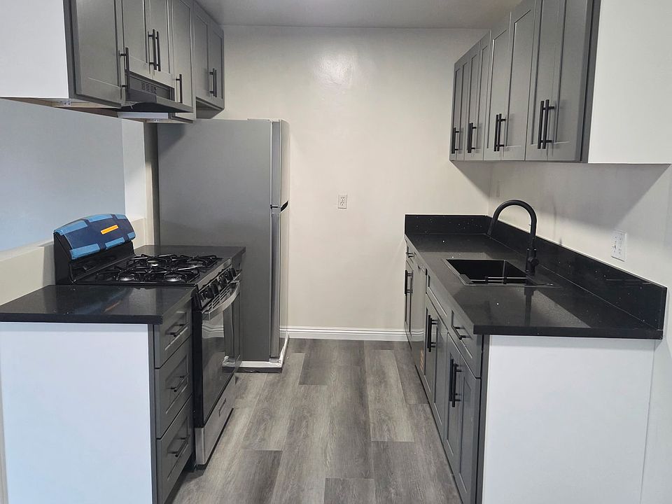 kitchen with new appliances. new stove, fridge, hood, dishwasher and sink.