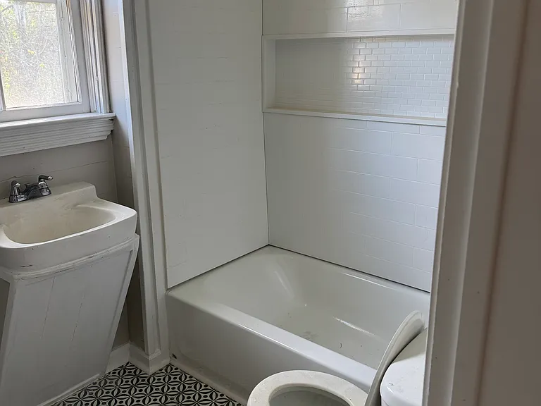 Completely new bathroom shower/tub, flooring, shelving.