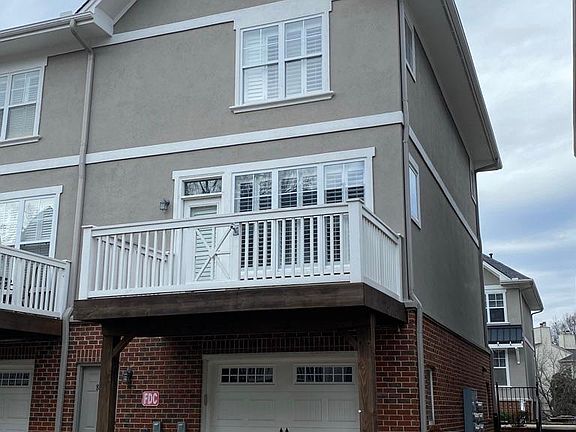 back view: balcony, garage, driveway