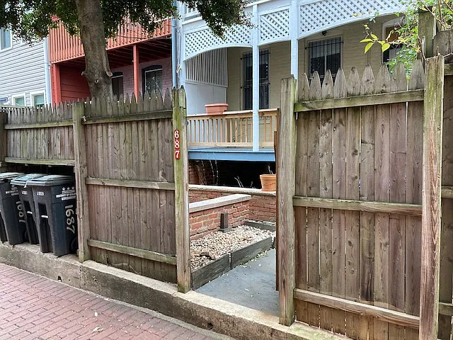 Back alley entrance and garbage can storage.