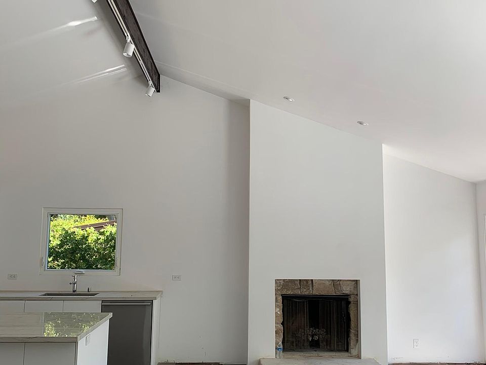 Main living room with open kitchen - access to deck, patio, and bedrooms from this floor