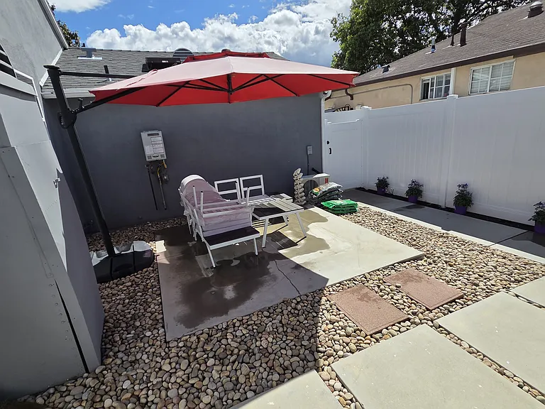 Courtyard w/ umbrella & patio furniture.