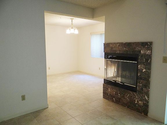 Corner fireplace from living room to dining area.
